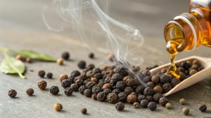 Black peppercorns with dripping amber liquid