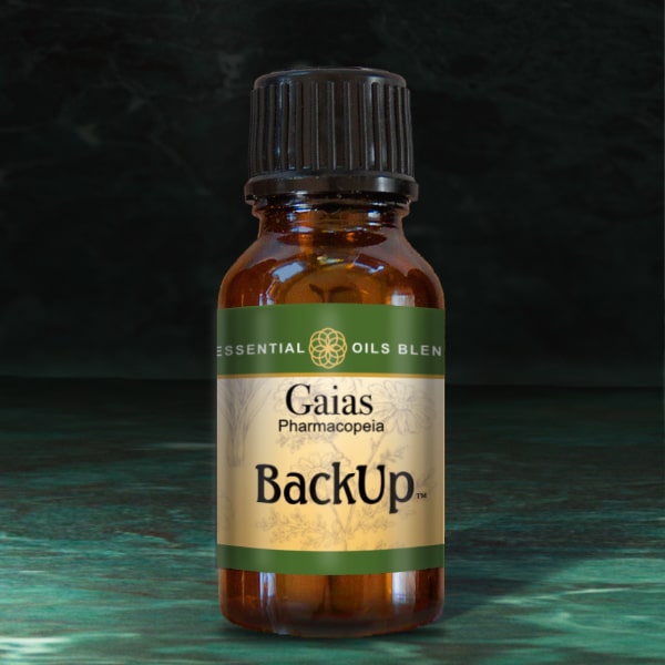 Gaias Backup essential oils blend bottle on dark background.