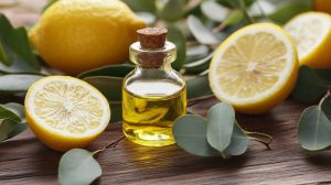 Lemon essential oil with fresh lemons and leaves.