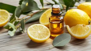 Lemon essential oil with fresh lemons and eucalyptus.